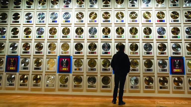 Visitors walk past the Gold Record Wall at the Country Music Hall of Fame in Nashville, Tennessee