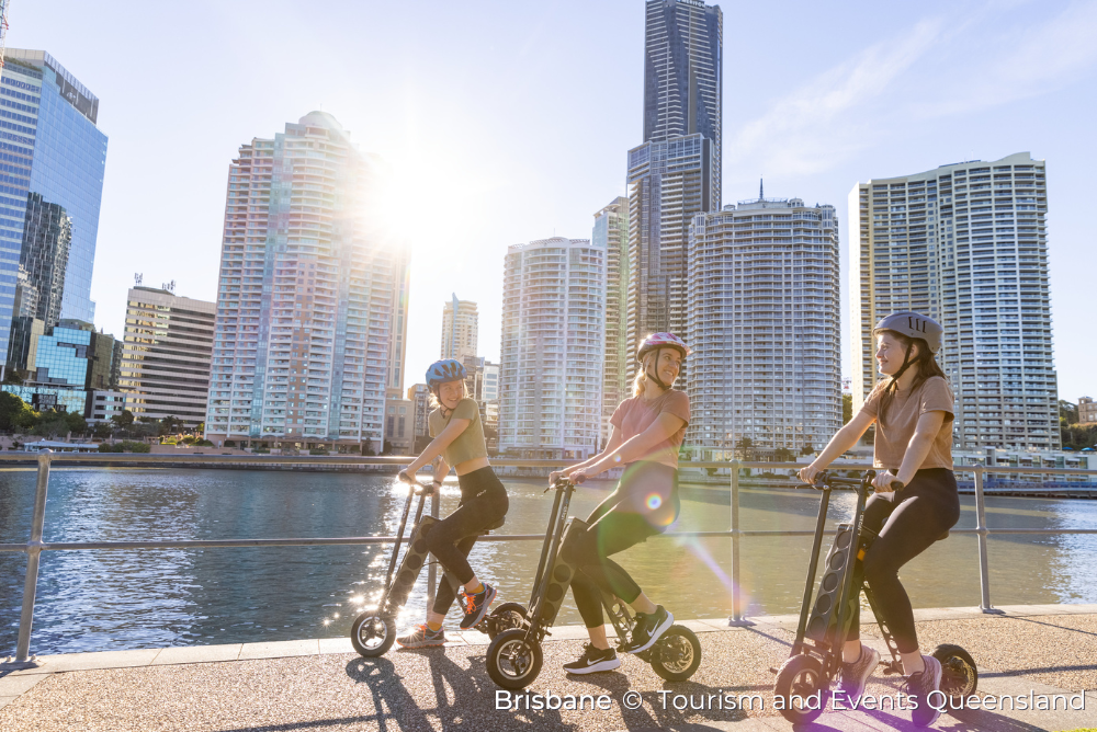 A group of ladies cycling along the riverside in Brisbane