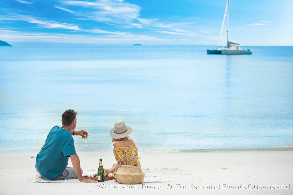 a couple having a picnic on Whitehaven Beach, Queensland