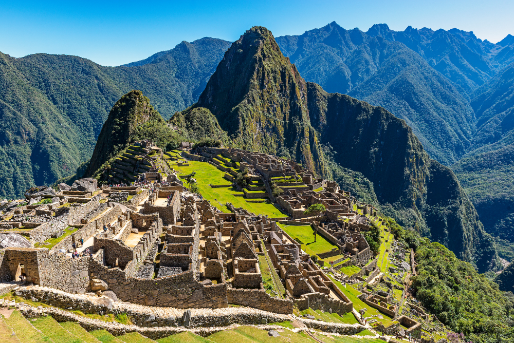The Inca Ruins of the lost city of Machu Picchu during daytime, with tourists visiting the site near the city of Cusco, peru, South America